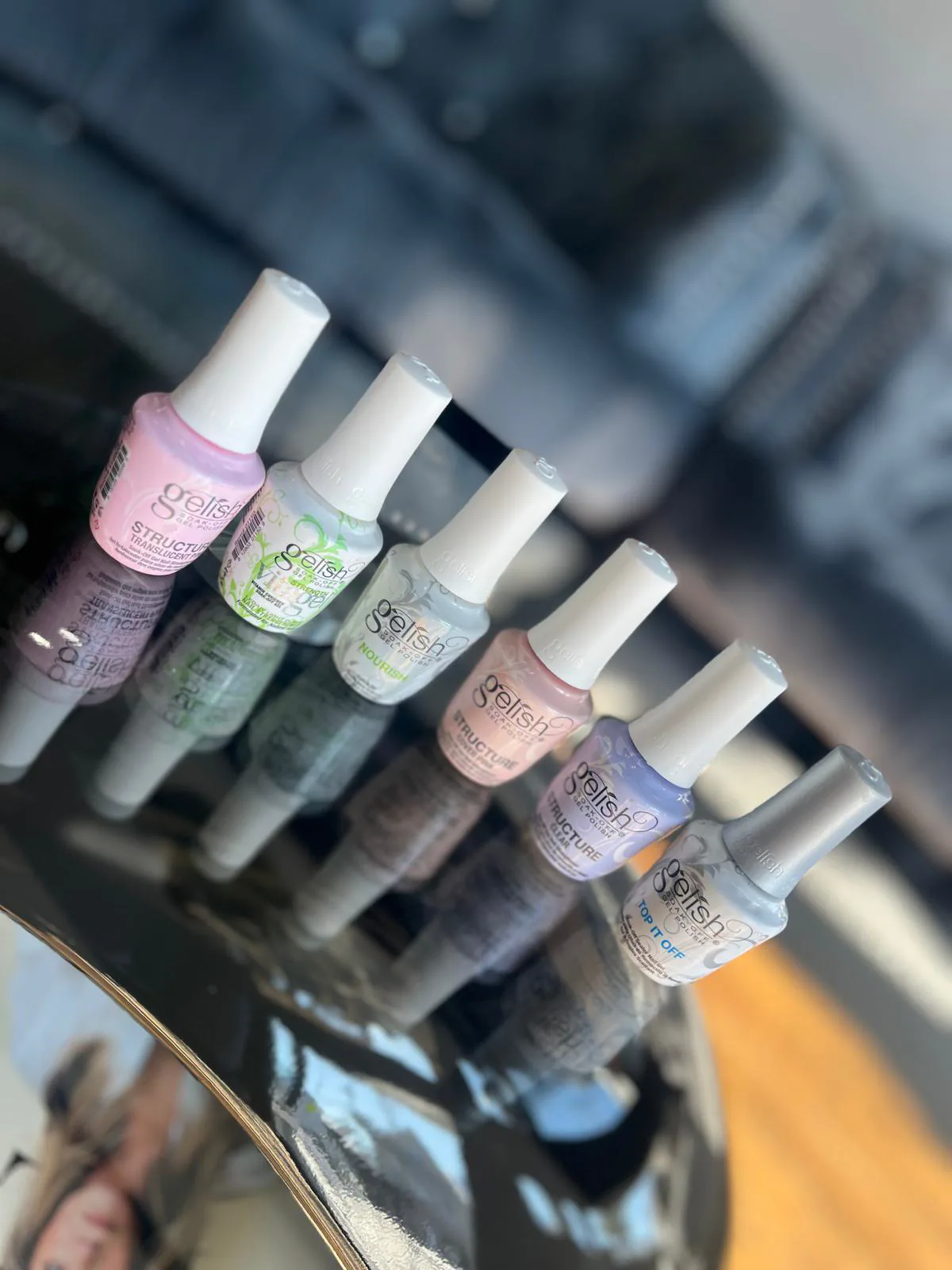 OPI and Gelish gel polish bottles lined up at Attraction Nails Salon